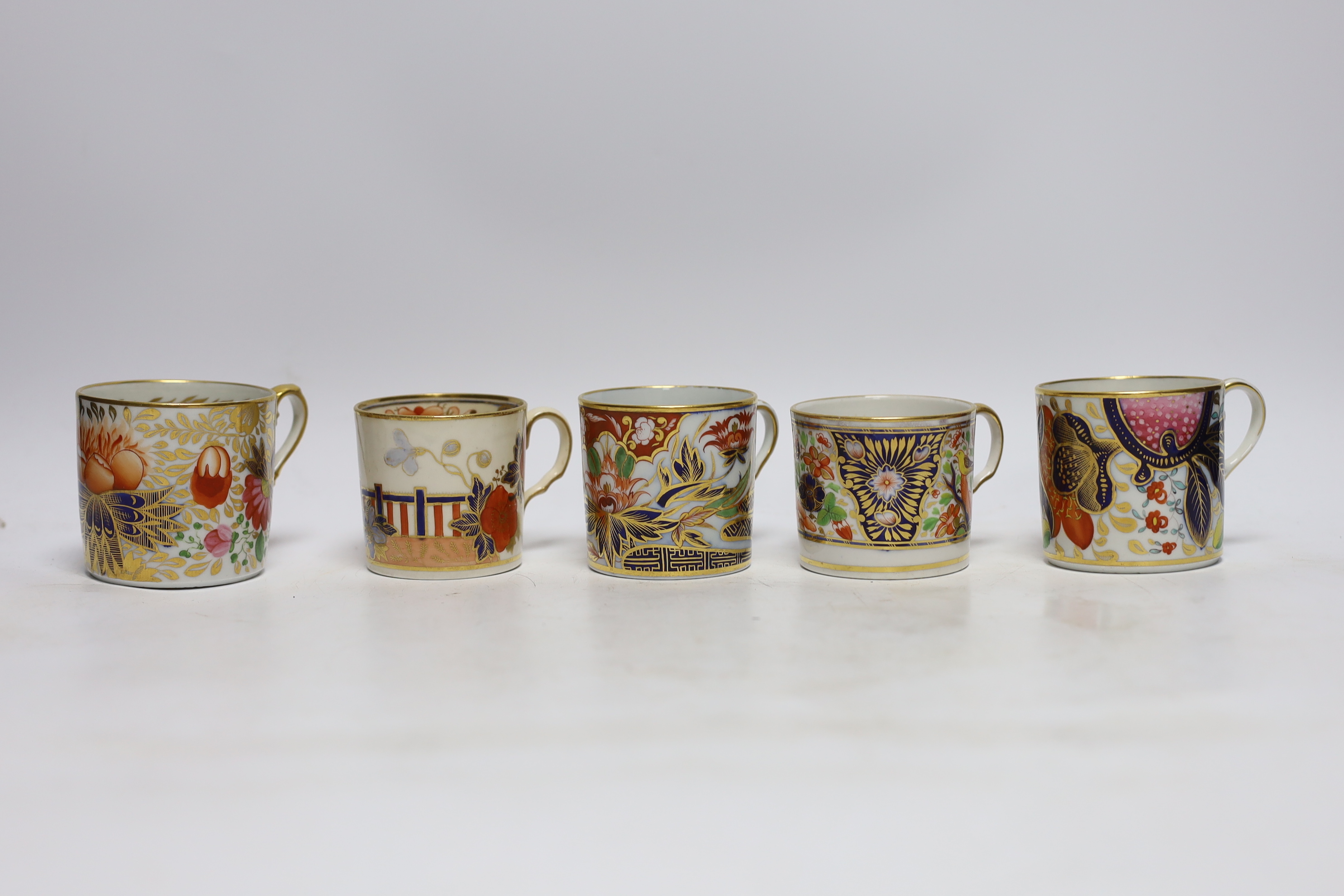 Twelve 1800-1820 English porcelain coffee cans, including Imari pattern examples
